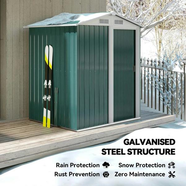 Green metal storage shed with sliding door, sloped roof, and side vents