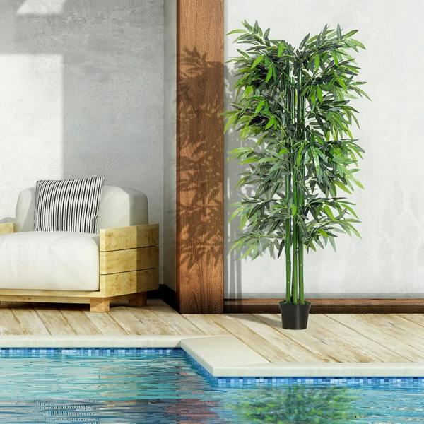 Artificial bamboo in a black pot with green trunks and dense leaves