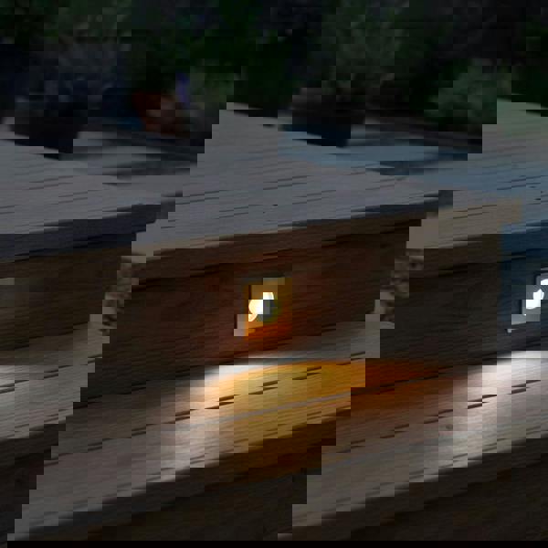 brass decking ground light recessed into wooden steps outdoors 