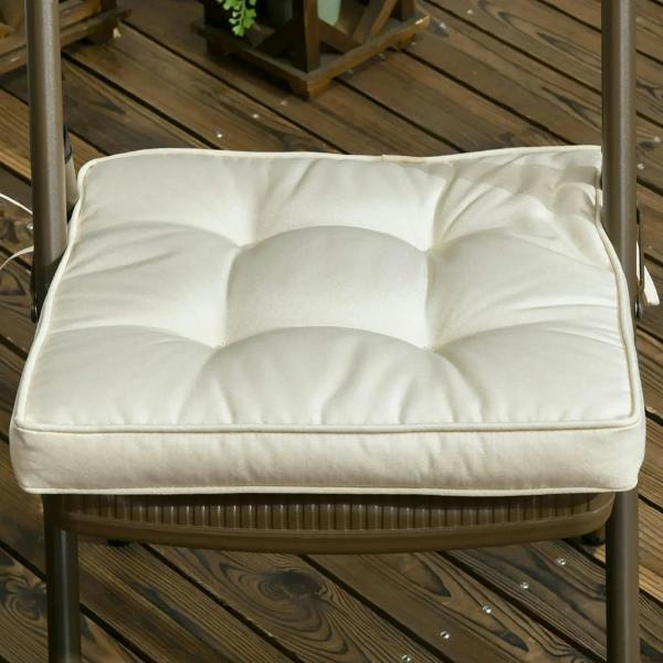 Cream padded seat cushion on chair seat, quilted tufted top