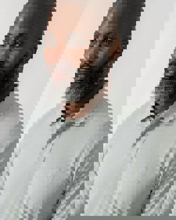 Model wearing BOSS Orange Passerby Mens Long Sleeve Stretch-Cotton Polo Shirt with Logo Patch in Silver 043 - Detail