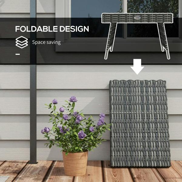 Foldable grey rattan side table with open support legs near a doorway
