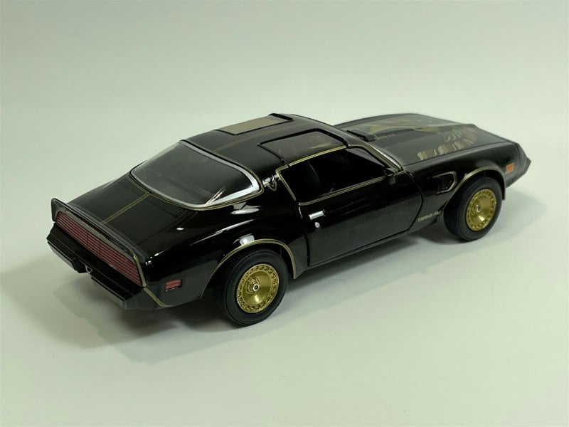 a black toy car with gold rims