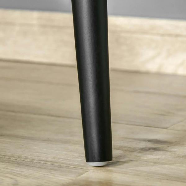 Black tapered vanity table leg with protective base.