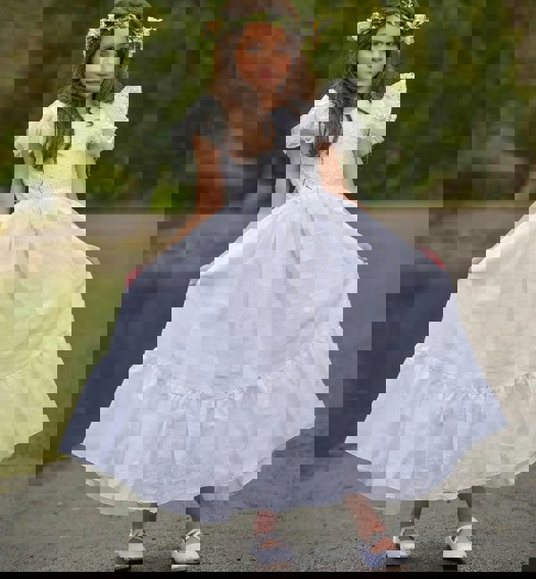 young girl holding a dress
