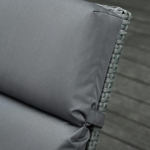 Dark grey cushion corner with securing tie around woven rattan lounge frame
