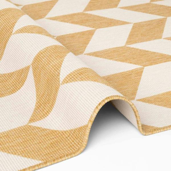 Close-up of a yellow and white geometric patterned rug.