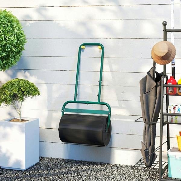 Black drum lawn roller with dark green handle on an outdoor patio surface
