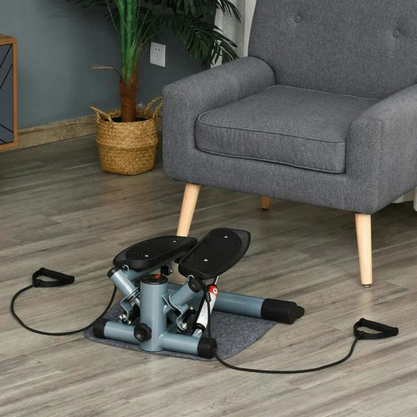 Mini stepper machine with black footplates, light gray base, and resistance bands on floor