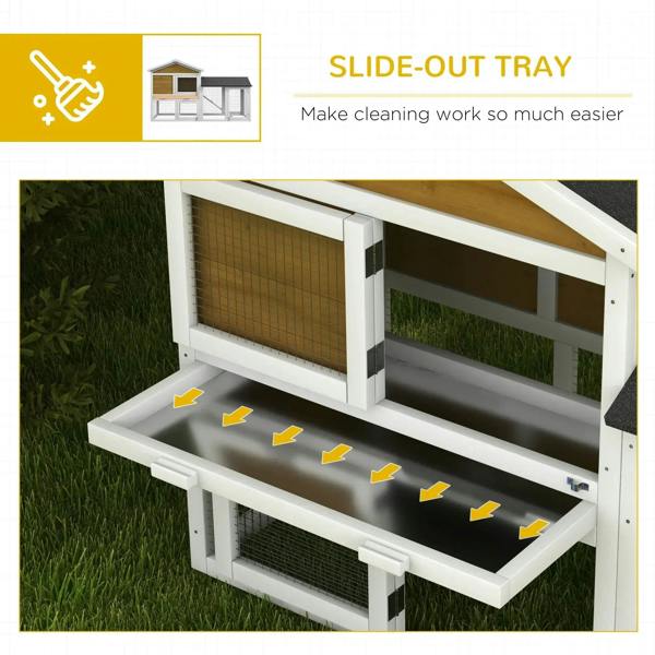 Yellow outdoor rabbit hutch with slide-out tray under wire run and dark roof