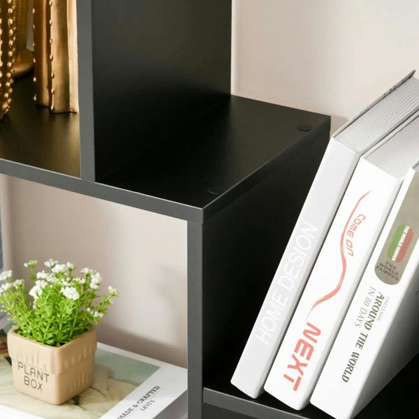 Black cube shelf insert with books standing upright on an open cubby