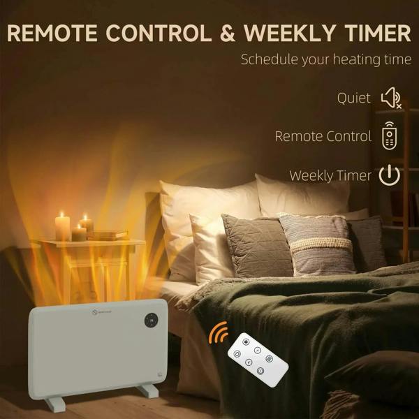 White electric convector heater with black thermostat dial and remote control beside it.