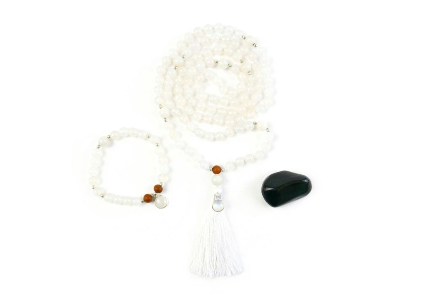 Kati Kaia white moonstone mala necklace set with tassel and matching bracelet displayed with black stone