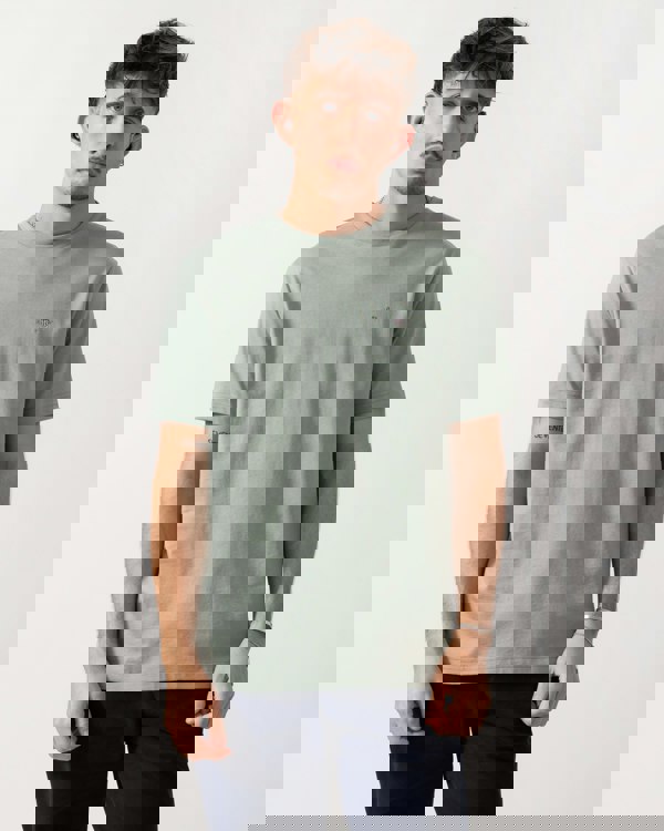 Model wearing a GANT Mens Regular Fit Short Sleeve Shield Logo T-Shirt in Ceramic Grey