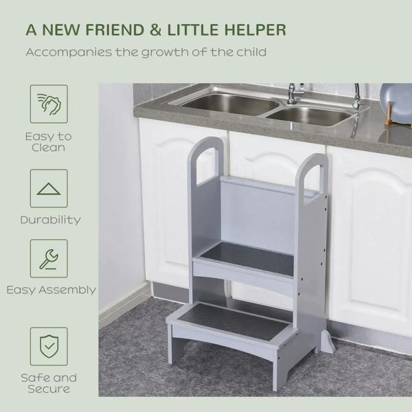 Grey wooden step stool with two steps and top handle frame beside sink
