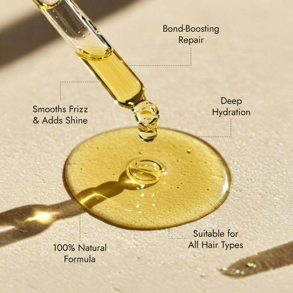 Rosemary hair oil bottle with dropper on a stone surface with natural light. Rosemary hair oil, argan, almond, bond, boost, hair growth, coconut oil, healthier, fuller-looking hair, stimulate, regrowth, hair thinning, natural, 100ml, benefits