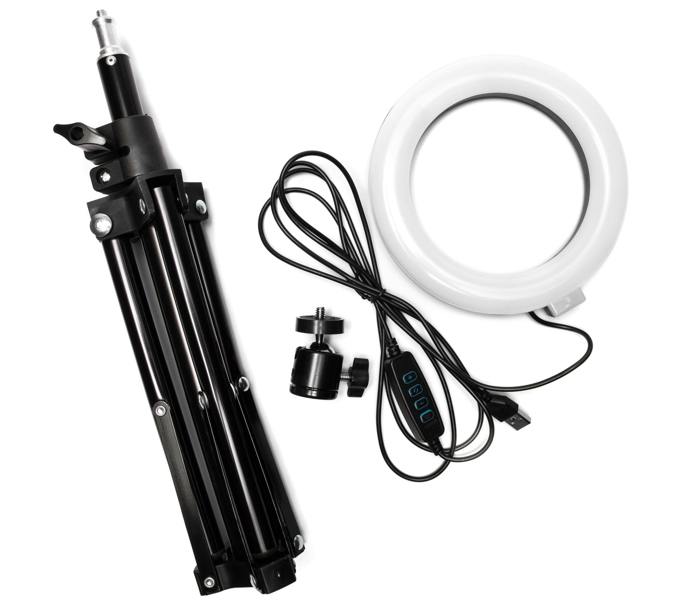 The Rio Makeup Perfector LED Ring Light includes a black tripod, circular white ring light, ball head mount, and USB cable with in-line controls—perfect for flawless makeup application in any lighting.