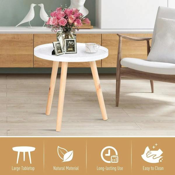 Round white coffee table with carved floral tray top and four light wood legs