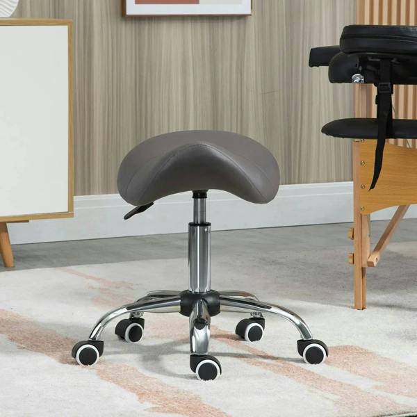Grey rolling cosmetic stool with curved saddle seat and chrome base with caster wheels