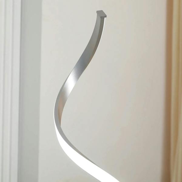 Silver spiral LED floor lamp with curved glowing tube and tall wavy stem