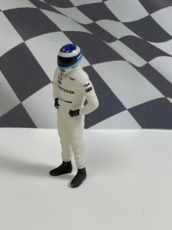 a toy figure of a race car driver