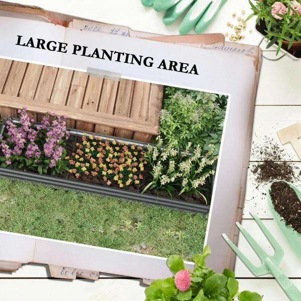Dark grey galvanized steel planter box with open bottom, soil bed and dense flowering plants