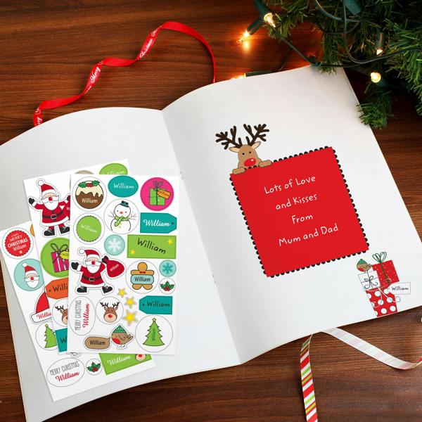 Open view of the Personalised Christmas Activity Book showing a custom printed message page from Mum and Dad alongside personalized Christmas sticker sheets