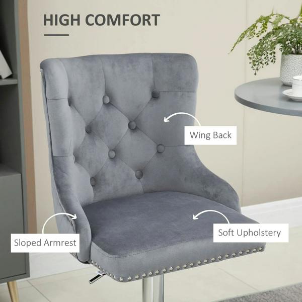 Grey velvet bar stool with wing back, padded armrests, tufted seat, and nailhead trim