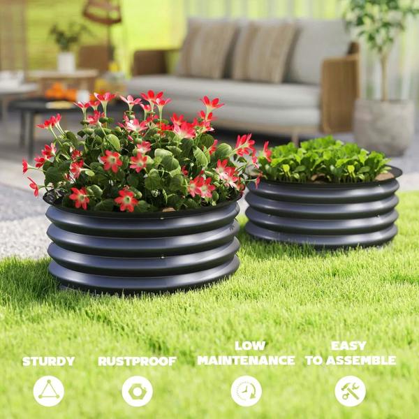 Set of 2 dark grey raised garden beds with pink flower and green herb plants on grass