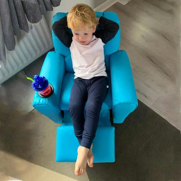 Blue kids recliner chair with padded headrest and built-in cup holder, child seated