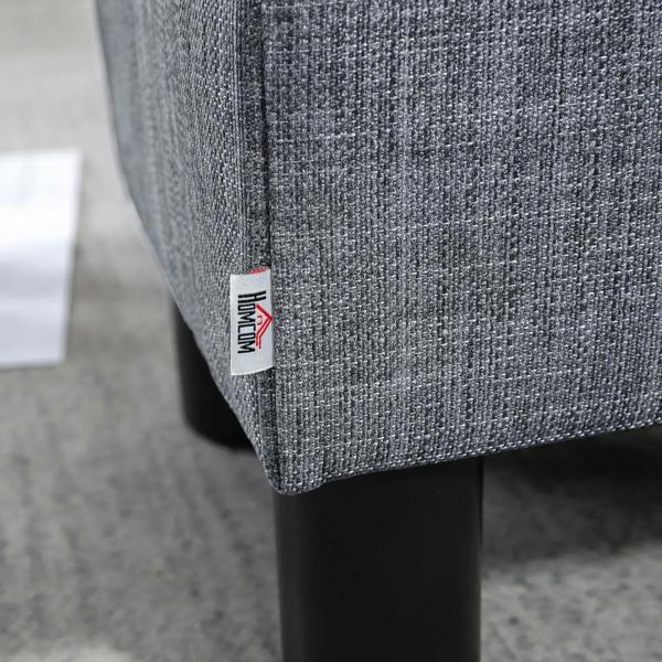 Grey linen ottoman footstool corner with fabric label and black plastic leg