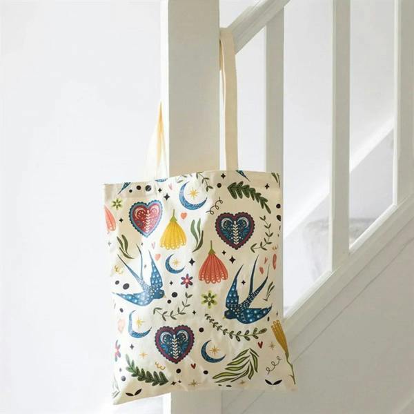 Cream polcotton tote bag with folk hearts, birds, moons and flower pattern