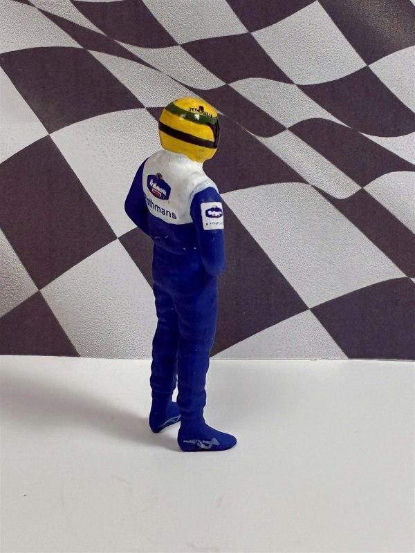 a toy figure of a race car driver