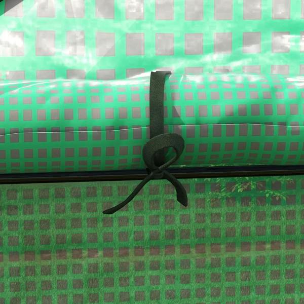 Green greenhouse cover with grommet and strap tie on the fabric surface