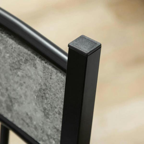 Close-up of black table leg corner with grey marble-effect tabletop edge