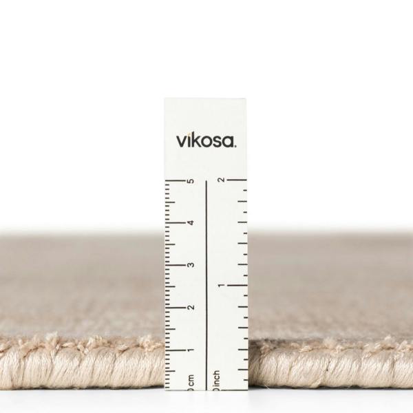 Rug with a ruler showing measurements and 'vikosa' branding on a white background