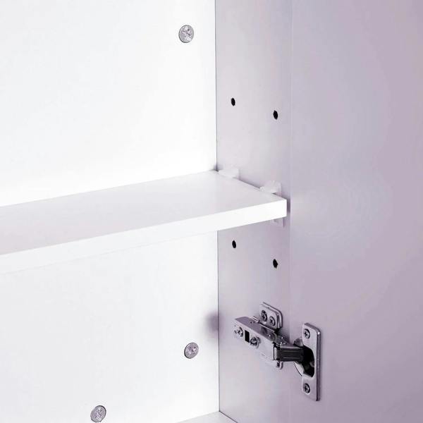Close-up of adjustable shelf supports and mounting holes inside a white bathroom cabinet
