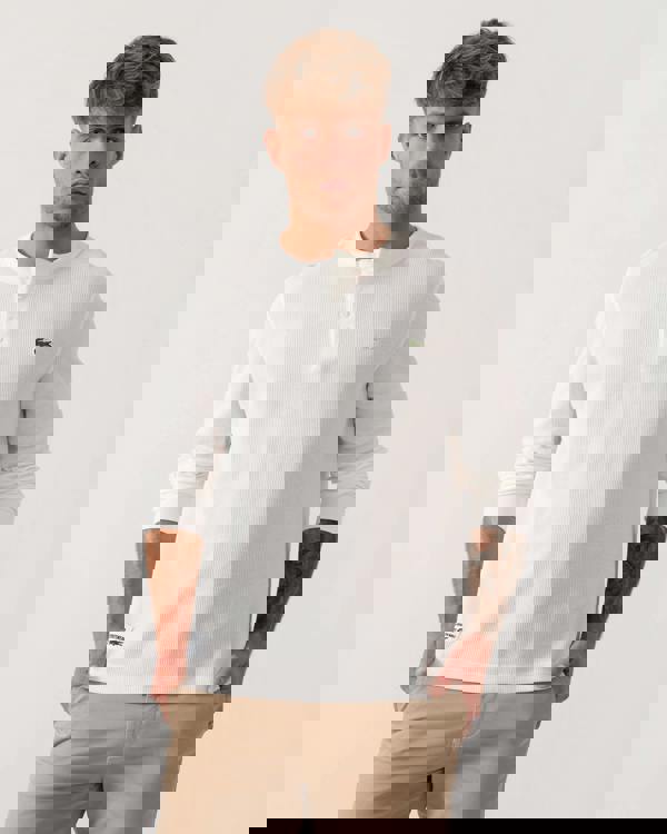 Model wearing Lacoste Boxy Tunisian Neck Knit T-Shirt in Flour 70V - Main