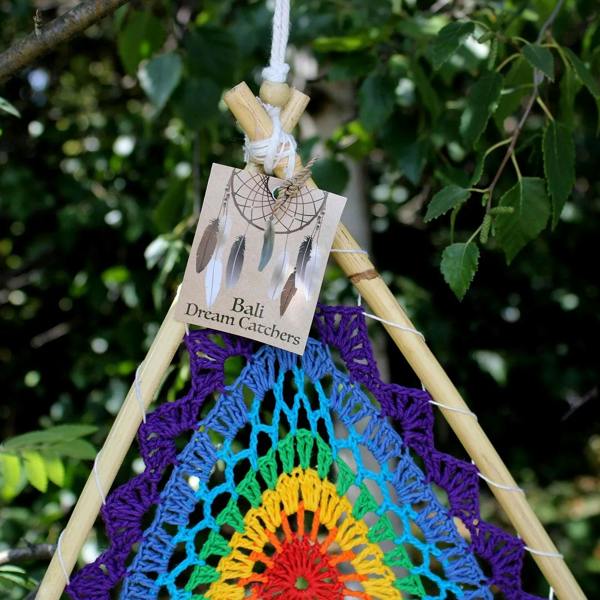 Close-up of multicolor Bali dream catcher pyramid with “Bali Dream Catchers” tag