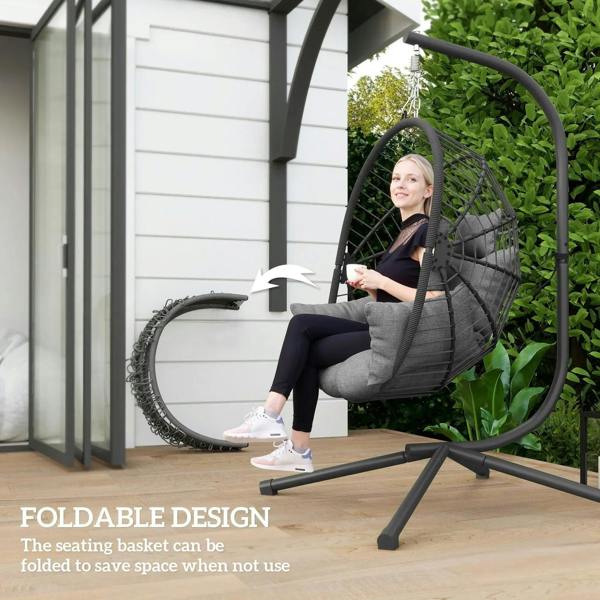 Grey hanging egg chair with foldable stand frame and padded seat cushion.