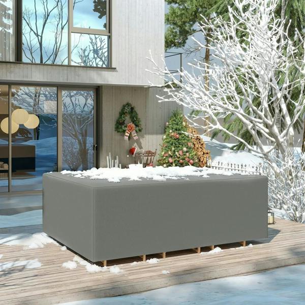 Dark gray outdoor sofa set cover fitted over a rectangular seat, with snow on top.