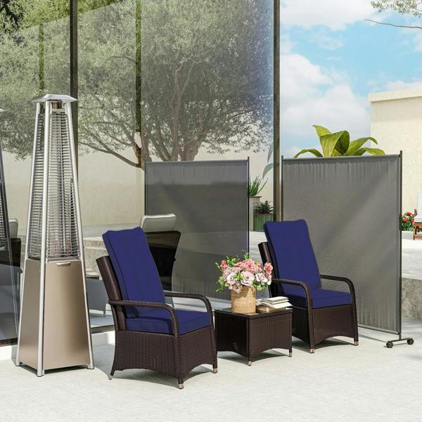Dark grey outdoor privacy screen panel on wheels between patio lounge chairs