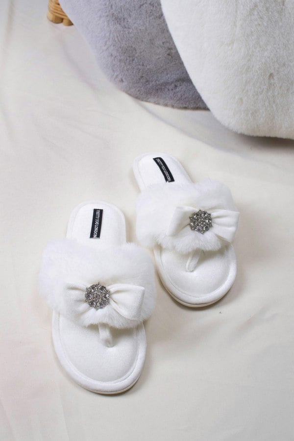 Amelie women's toe post slippers in cream with a premium velvet bow and diamante embellishment atop a plush faux fur band from Pretty You London