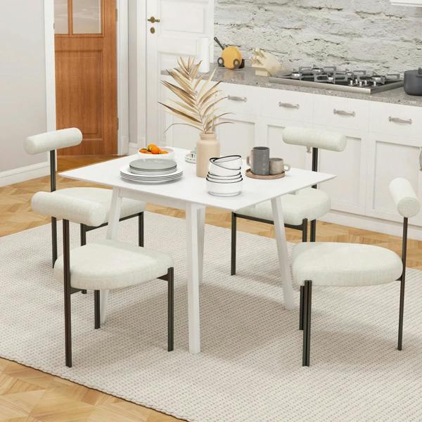White drop-leaf folding dining table with upholstered chairs in a kitchen setting
