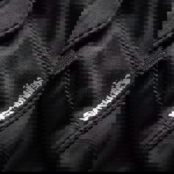 Scruffs Slim Fit Mens Trade Workwear Trade Joggers, close-up of black fabric with branding logo.