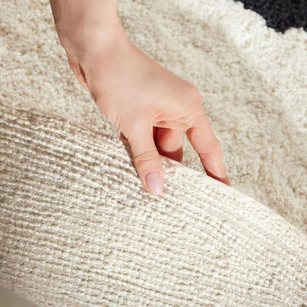 Hand touching textured beige fabric