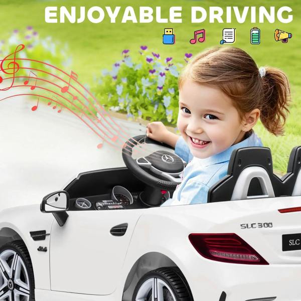 White kids electric ride-on car with child sitting and front dashboard controls visible.
