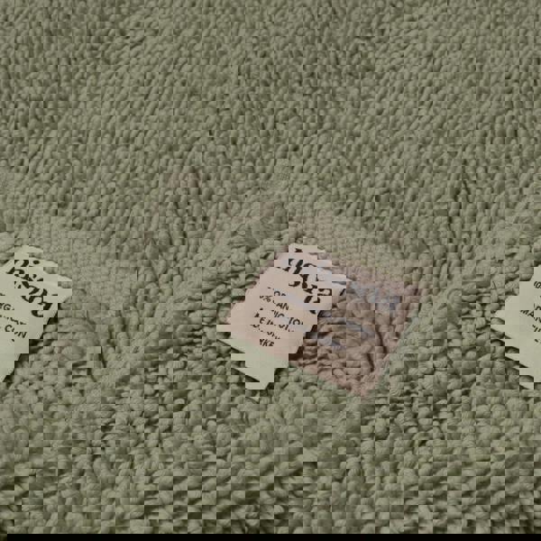 Sage green bath mat made from sustainable organic cotton.