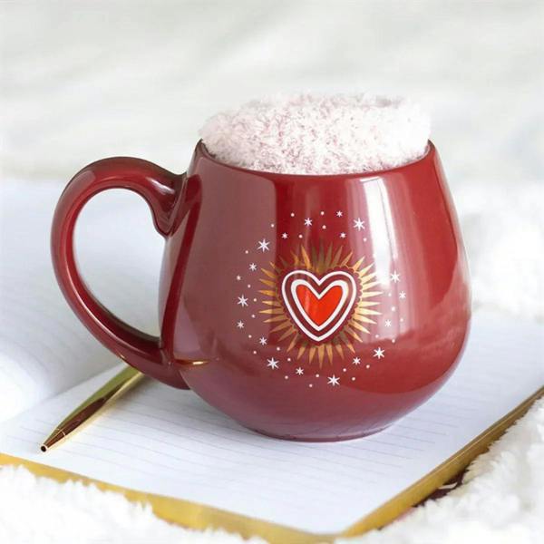 Red ceramic mug with fuzzy top and heart-and-stars design on the front.