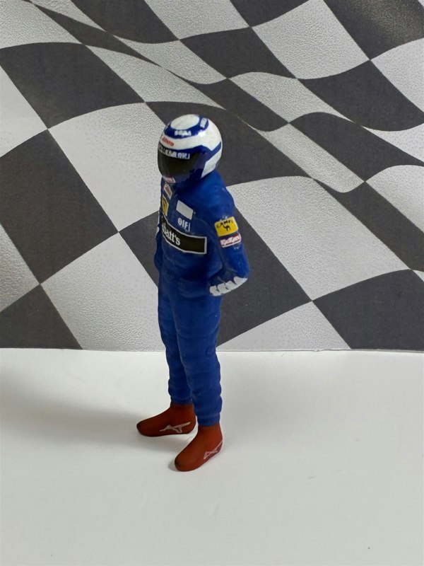 a toy figure of a race car driver